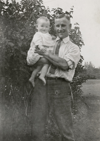 Father and his 1 year old daughter at the city of Saskatoon in Saskatchewan, Canada. Vintage photograph ca. 1925.