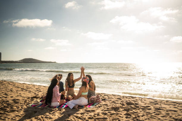 istock Female friends dancing during a celebration on the beach 1489807096