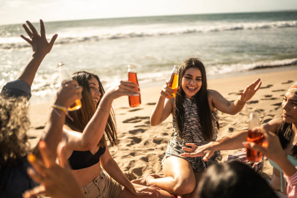 Female friends dancing during a celebration on the beach