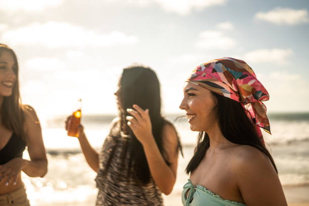 Female friends dancing during a celebration on the beach