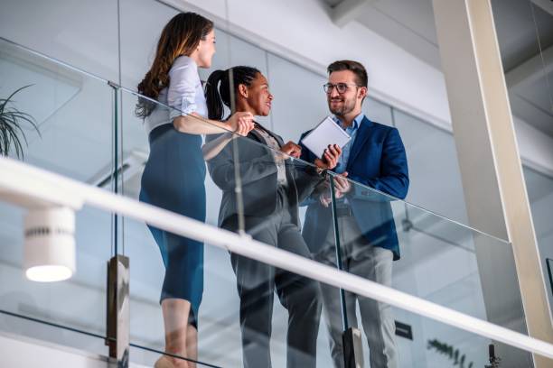 istock Business people leaning against a glass fence and using a digital tablet 1489807438