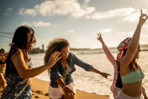 istock Female friends having fun while walking on the beach 1489807973