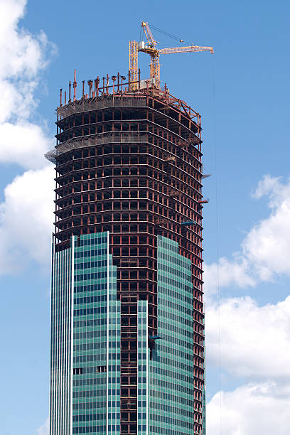 istock hoisting crane on top of construction building 148981119