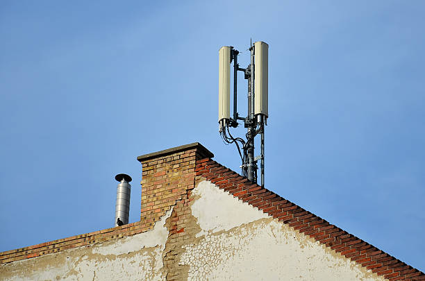 Cell Phone Antenna on the roof of a house stock photo