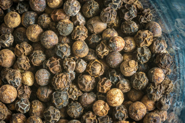 istock Dry black pepper inside glass jar closeup 1489811984