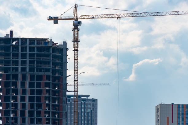 istock Industrial construction cranes work above new modern building. 1489813900
