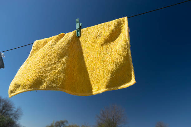 istock Clothes peg on a towel and washing line against a blue sky 1489815423