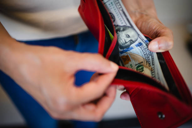 istock Man hand with a stack of US dollars bills 1489815972
