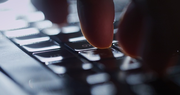 Hands on a computer or laptop keyboard. Typing and working digitally