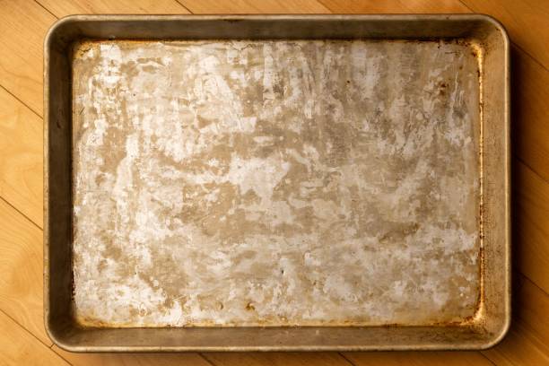 istock Top view of a rustic baking sheet on a wooden surface 1489816284
