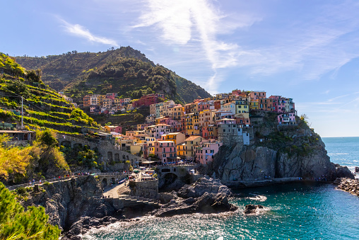 Manarola Village, stacked colorful villas in the province of La Spezia, Liguria, northern Italy, on the Cinque Terre coastline.