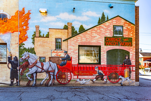 Historic mural of the fire brigade on the facade of Wilmot Township Fire Station, New Hamburg, Canada.