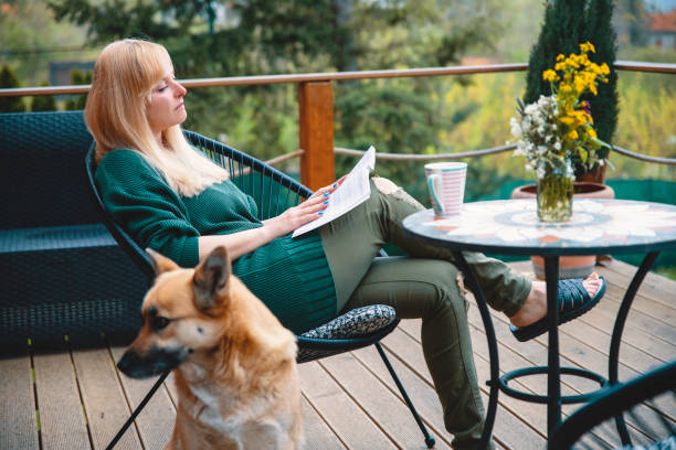 istock Enjoying with book and her dog on a patio 1489819141