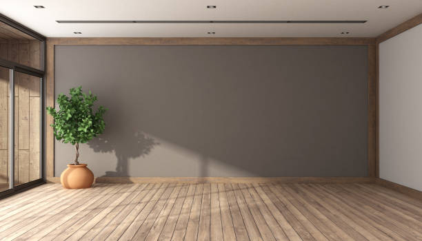 istock Empty room with brown wall and hardwood floor 1489820875