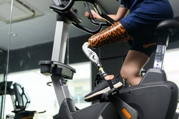 istock Disabled athlete patient with prosthetic leg doing exercise at gym 1489824348