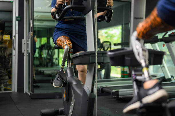 istock Disabled athlete patient with prosthetic leg doing exercise at gym 1489824676