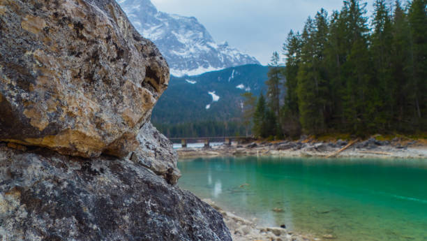 istock Rocks in Front of Mountain Lake Alps 1489826232
