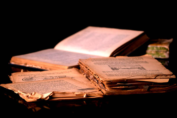 istock old books on a table with a black background 1489829034
