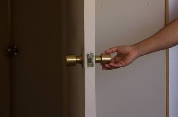 istock people's hands, opening a door at the same time. 1489829934