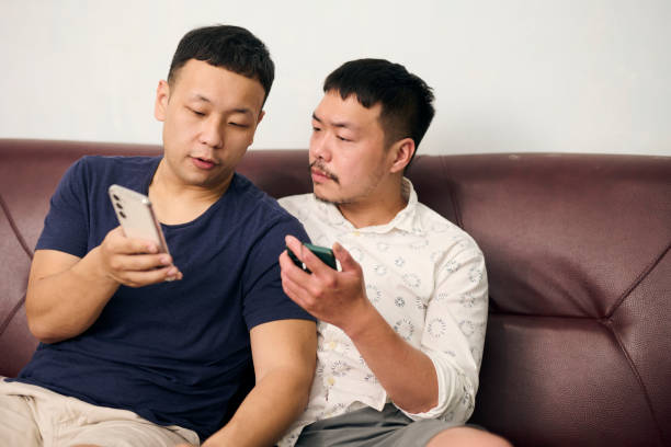 istock Gay couple use tablet. 1489830430