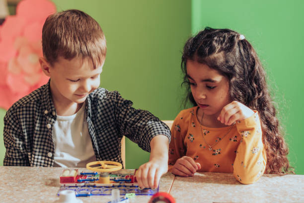 istock Group of diverse kids playing an electronic constructor in the classroom.STEM-education,hobby,technology concept 1489832093
