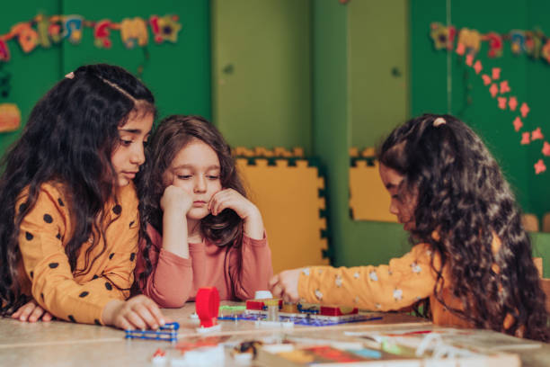 istock Happy little multiethnic girls playing an electronic constructor in the classroom.STEM-education,hobby,technology concept 1489832153