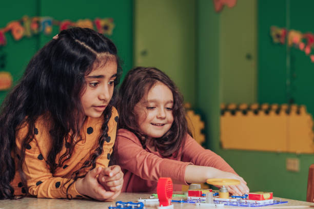 istock Happy little multiethnic girls playing an electronic constructor in the classroom.STEM-education,hobby,technology concept 1489832378