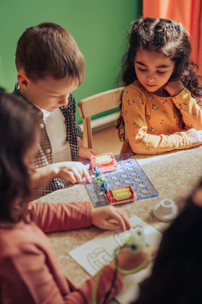 istock Group of diverse kids playing with an electronic constructor,using digital device in the classroom.STEM-education,hobby,technology concept 1489832697