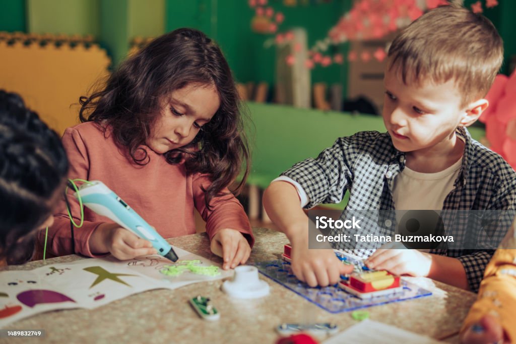 Children Playing Using Science Math And Technology Group Of Diverse Kids Playing With An Electronic Constructor Using ...