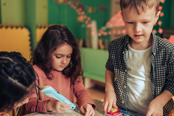 istock Group of diverse kids playing with an electronic constructor,using digital device in the classroom.STEM-education,hobby,technology concept 1489832773