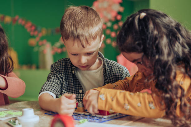 istock Group of diverse kids playing an electronic constructor in the classroom.STEM-education,hobby,technology concept 1489832811