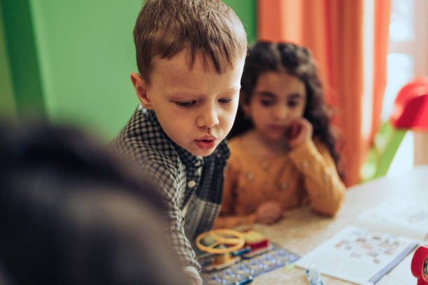 istock Group of diverse kids playing an electronic constructor in the classroom.STEM-education,hobby,technology concept 1489832830