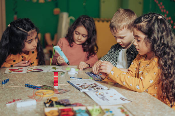 istock Group of diverse kids playing with an electronic constructor,using digital device in the classroom.STEM-education,hobby,technology concept 1489832831