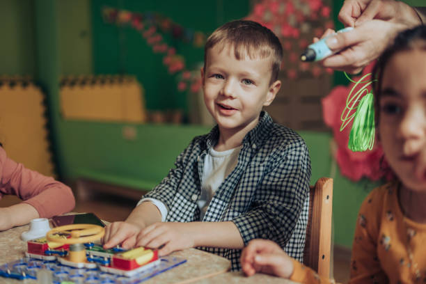 istock Group of diverse kids playing an electronic constructor in the classroom.STEM-education,hobby,technology concept 1489833459