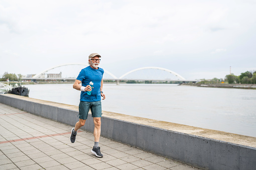Active senior man is jogging. Healthy retirement lifestyle