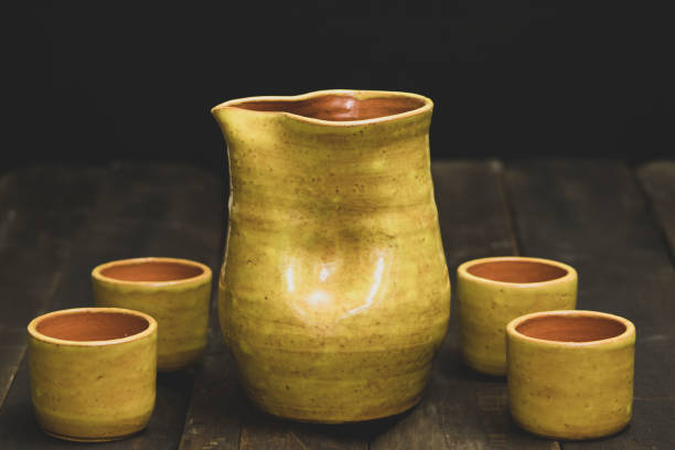 istock rustic ceramic vase on aged wood with black background 1489835827