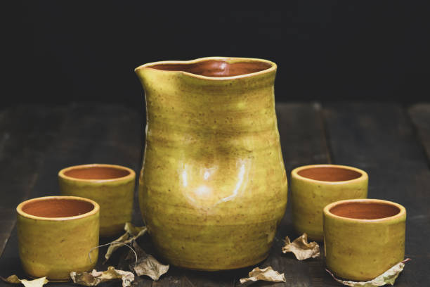 istock rustic ceramic vase on aged wood with black background 1489835828