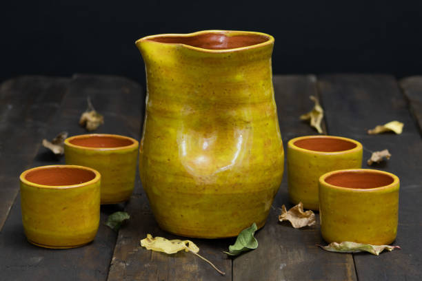 istock rustic ceramic vase on aged wood with black background 1489835845