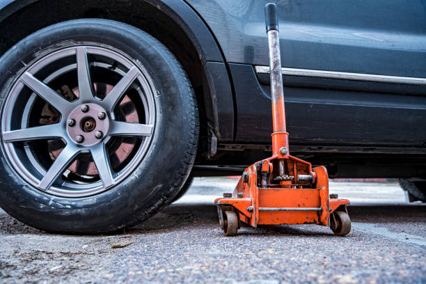 istock car is jacked using an automobile hydraulic jack 1489835902