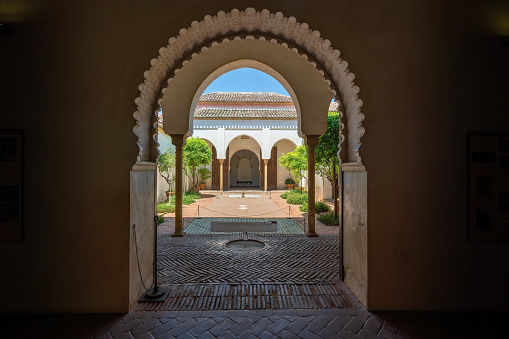 Malaga, Spain - May 18, 2019: Patio de los Naranjos (Orange Tree Courtyard) in Nasrid and Taifa Palace at Alcazaba Fortress - Malaga, Andalusia, Spain