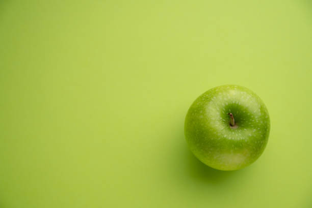 istock Green Apple and green background 1489836569