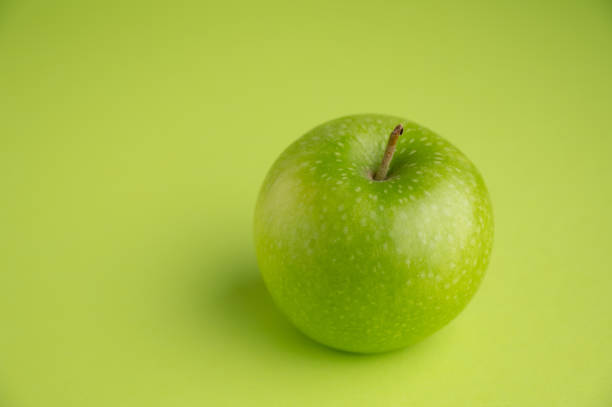 istock Green Apple and green background 1489836641