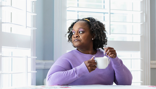 Mature African-American woman having morning cup of tea