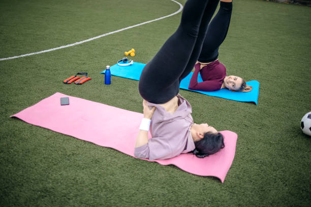 young woman exercising outdoors. - playing field effort outdoors human age imagens e fotografias de stock