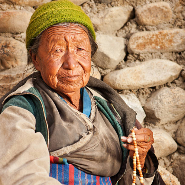 istock Tibetan woman with rosary 148984210