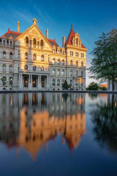 New York state capitol in Albany reflected in water at sunset