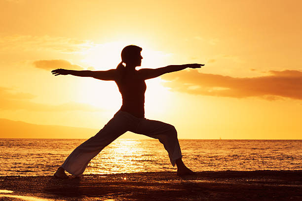 istock Woman Practicing Yoga at Sunset 148984638