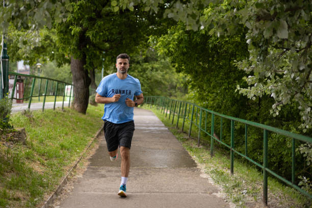 istock Happy man running in the park on a summer sunny day 1489858768