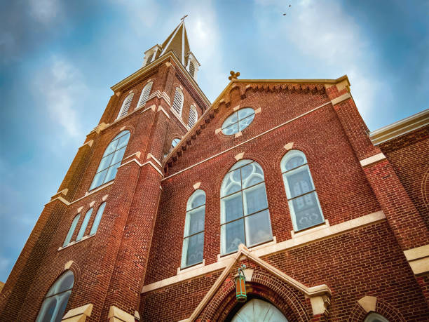 Historic Church Cathedral Reaching Towards the Sky A majestic ornate old church stands tall against a dramatic blue sky. Ornate architectural details and stained glass windows. Set in the downtown historical district in Springfield, Illinois, USA. place of worship stock pictures, royalty-free photos & images