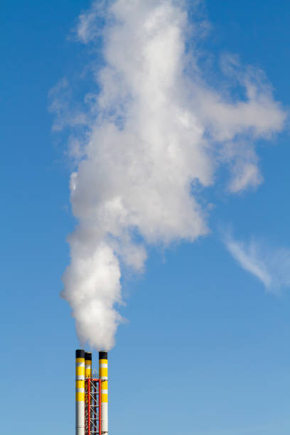 Chimneys emit smoke and pollute the air stock photo